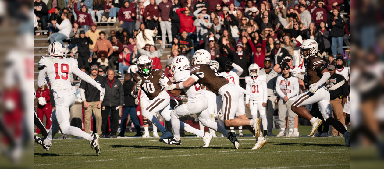 Lehigh vs. Lafayette during a play on the field, during a Rivalry game. A Lehigh football player tackles a Lafayette player.