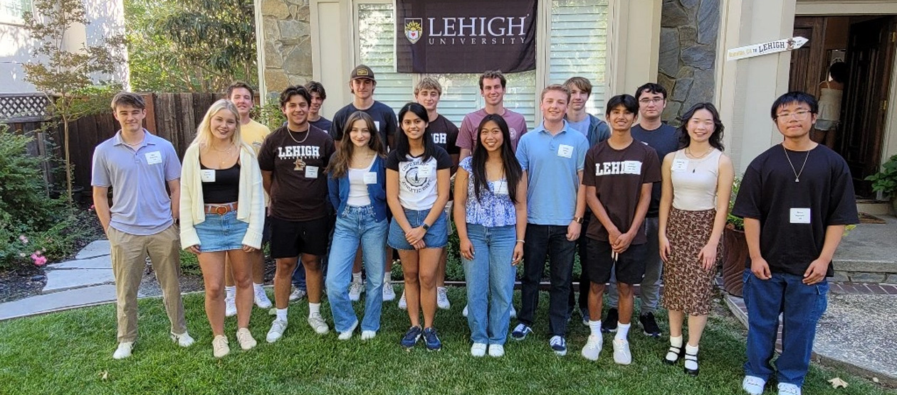 students gather for a group Sendoffs photo outside of a home 