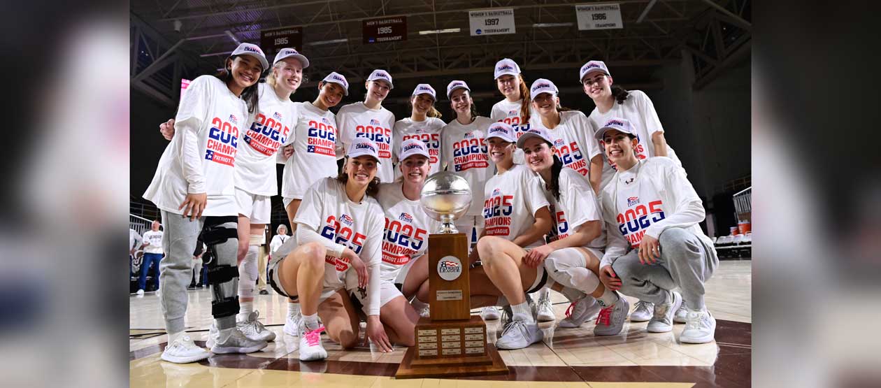 Lehigh Women's Basketball team gather around a trophy for a group photo